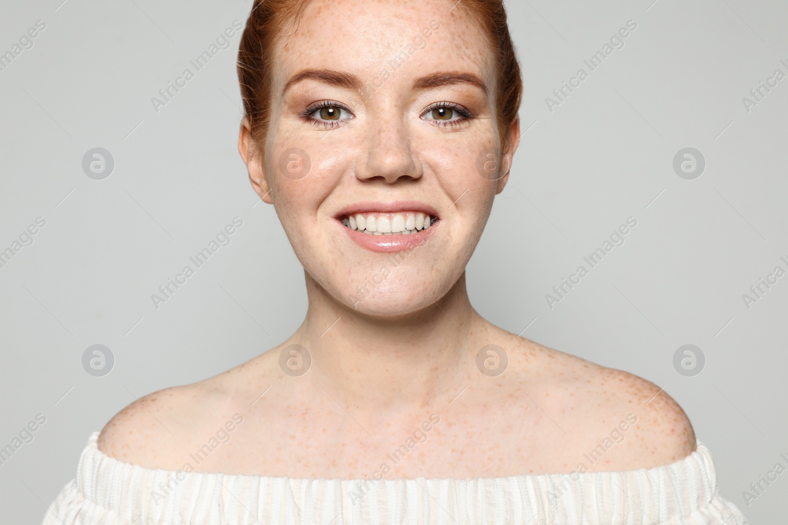 Photo of Portrait of young woman with beautiful face on grey background, closeup