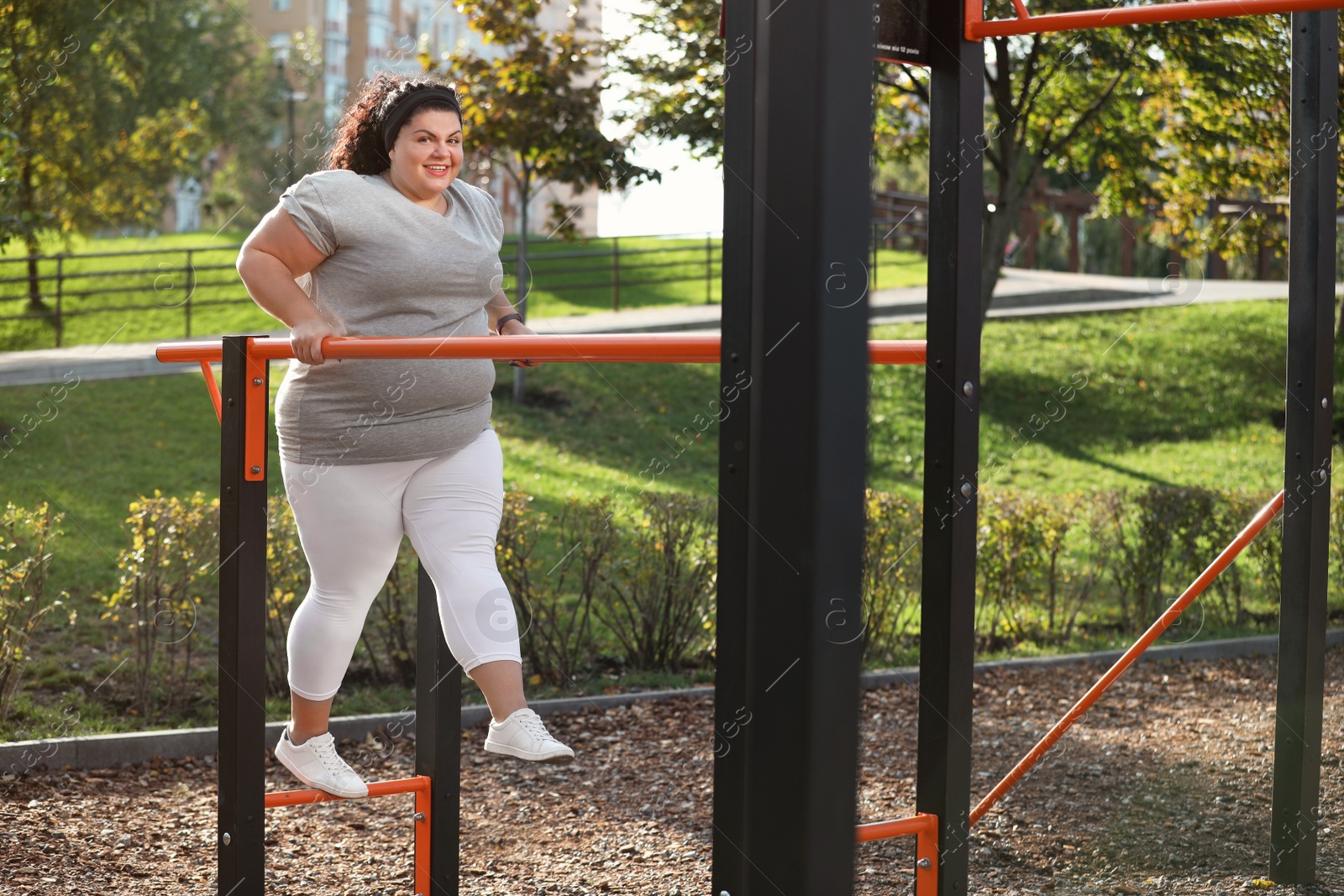 Photo of Beautiful overweight woman training on sports ground