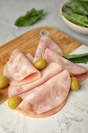 Photo of Ham with olives and spinach on table