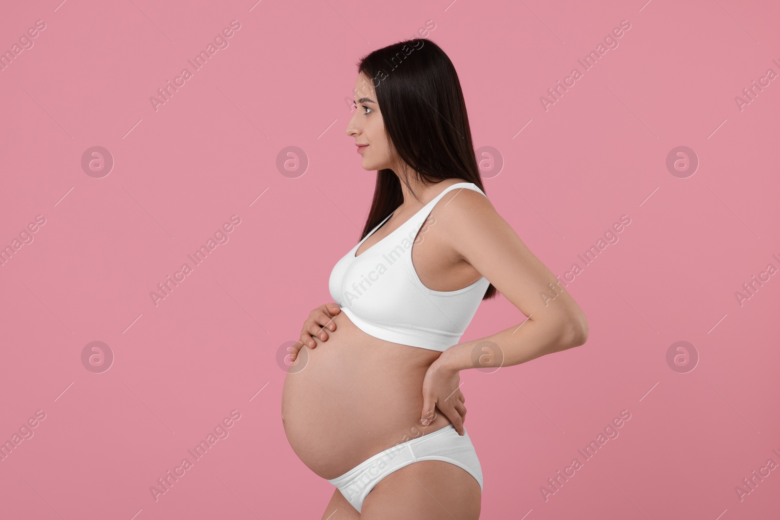 Photo of Beautiful pregnant woman in stylish comfortable underwear on pink background