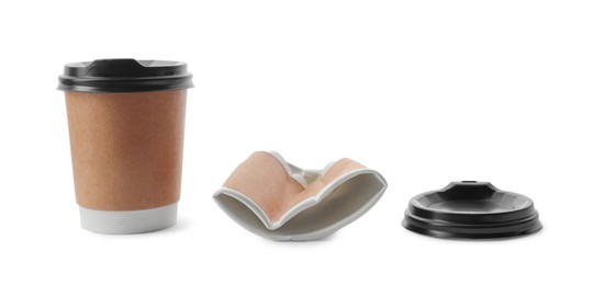 Photo of New and crumpled takeaway paper coffee cups on white background