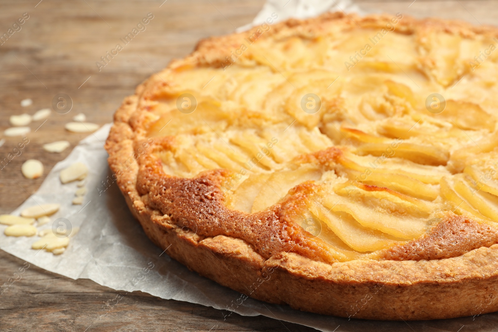 Photo of Delicious sweet pear tart on wooden table, closeup