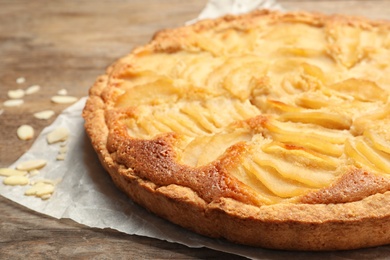 Photo of Delicious sweet pear tart on wooden table, closeup