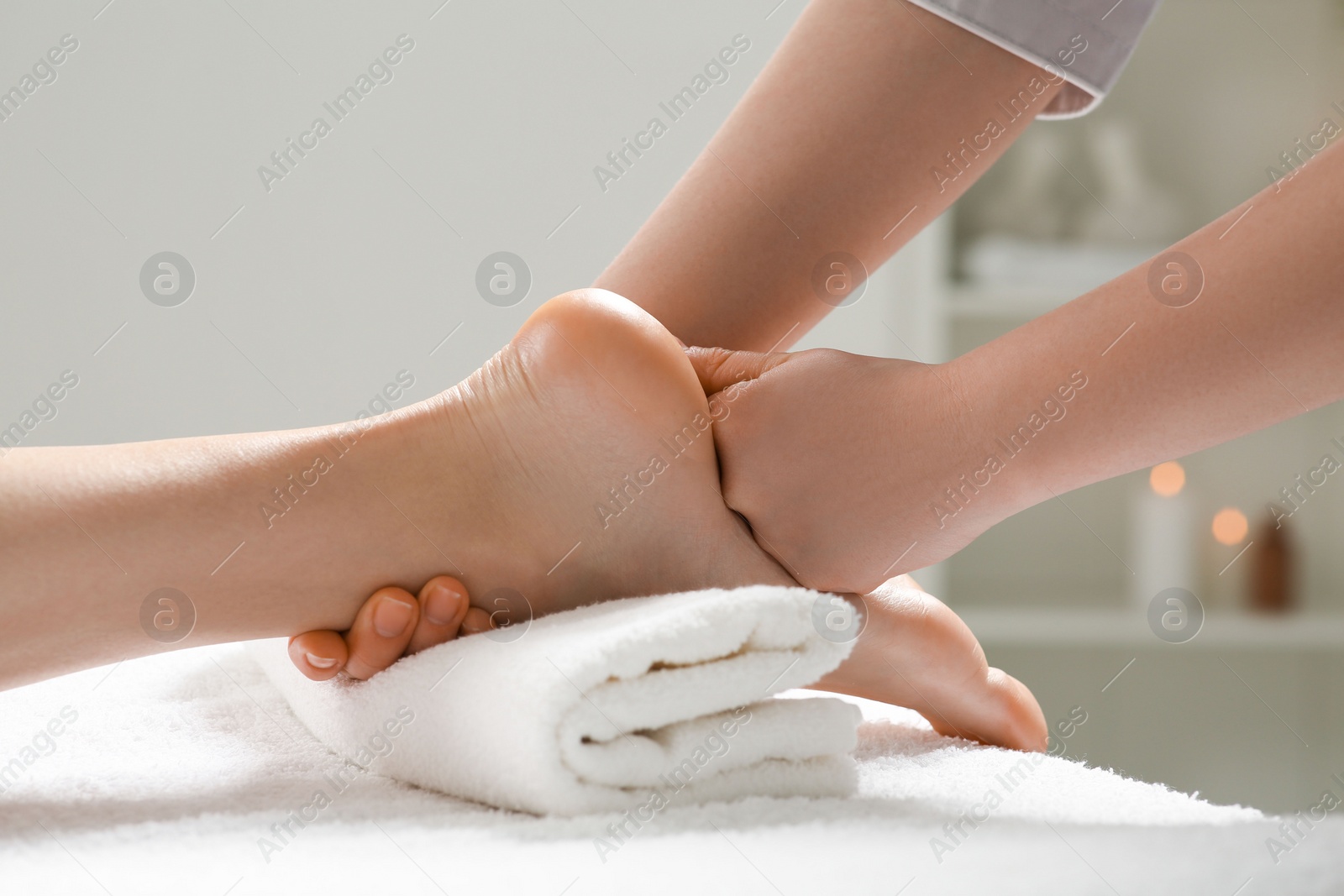 Photo of Woman receiving foot massage in spa salon, closeup