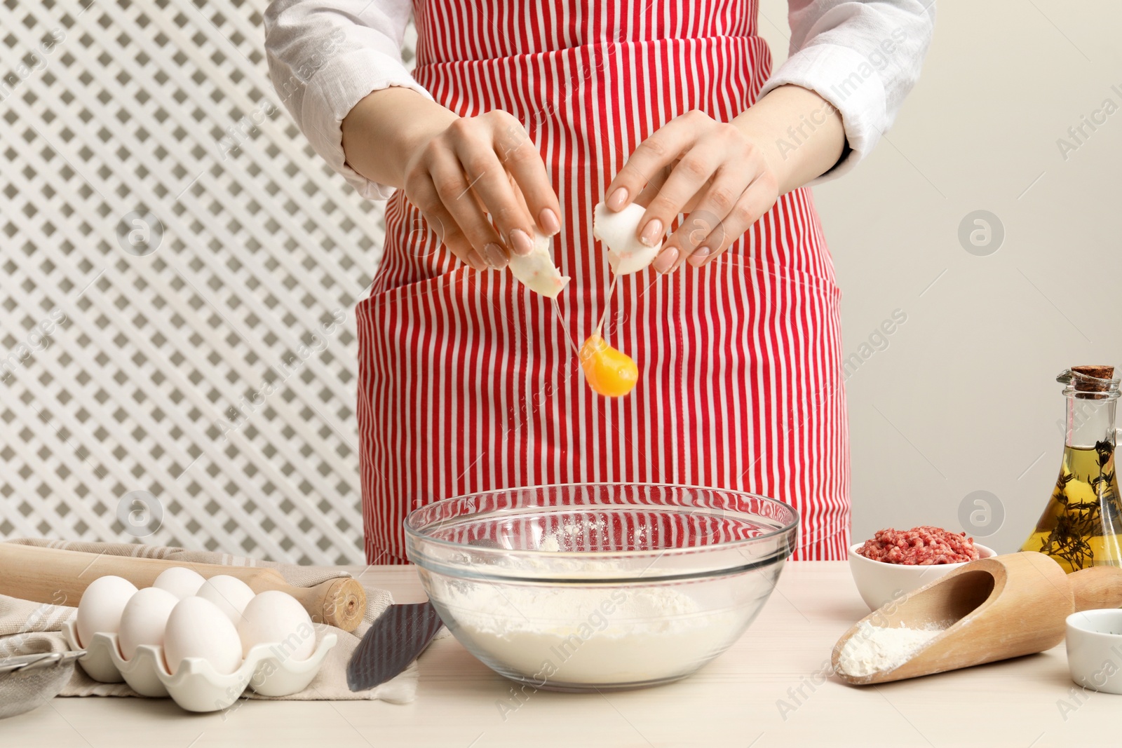 Photo of Woman making dough at white wooden table, closeup