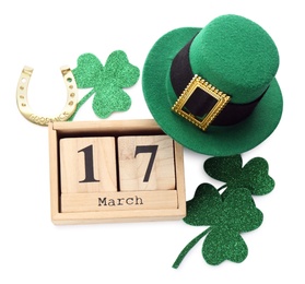 Photo of Leprechaun's hat, block calendar and St. Patrick's day decor on white background, top view