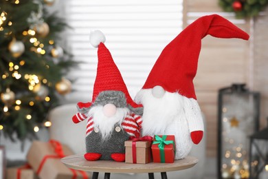 Photo of Cute Scandinavian gnomes and Christmas gift boxes in room