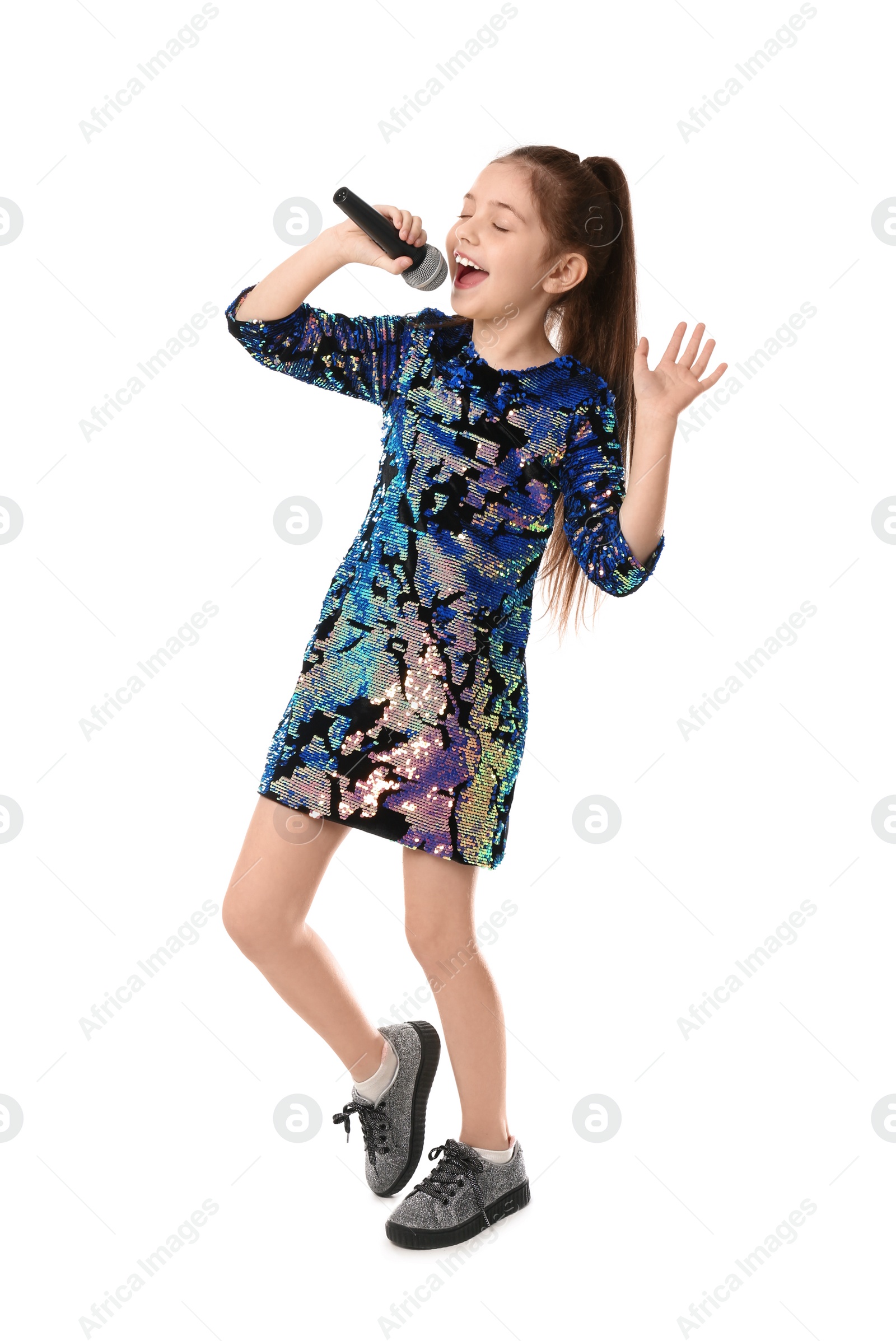 Photo of Little girl singing into microphone on white background