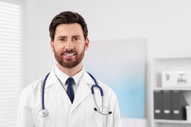 Medical consultant with stethoscope in clinic, space for text