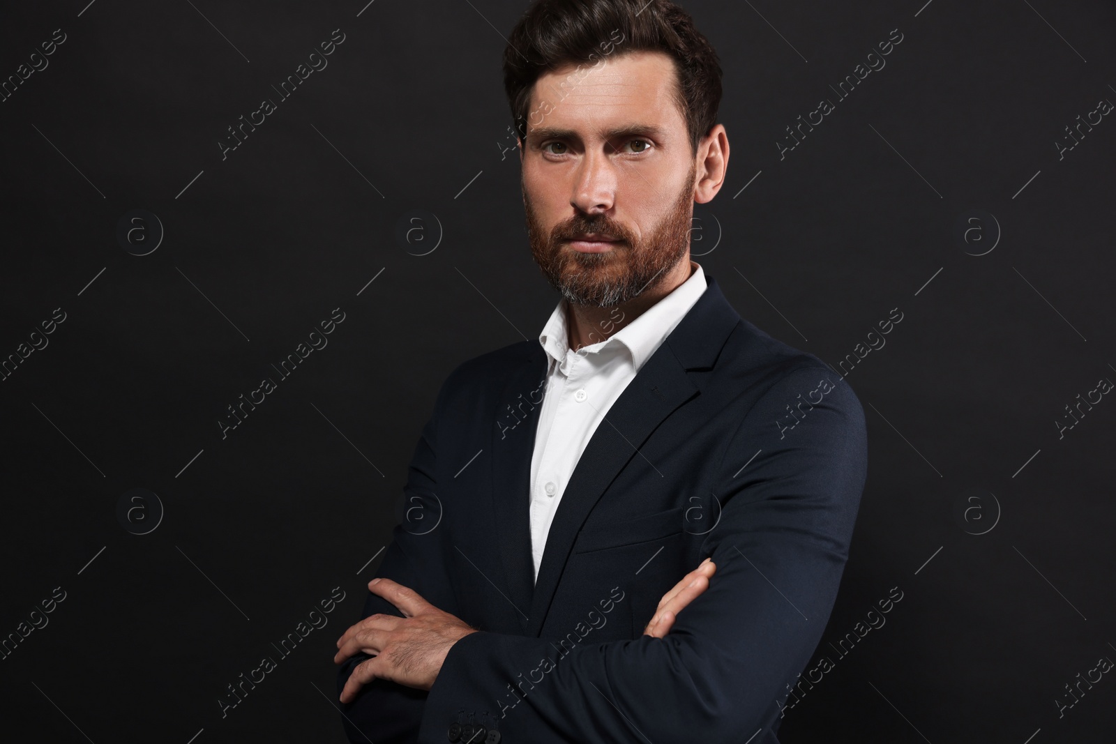 Photo of Portrait of handsome bearded man on black background. Space for text