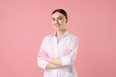 Photo of Cosmetologist in medical uniform on pink background