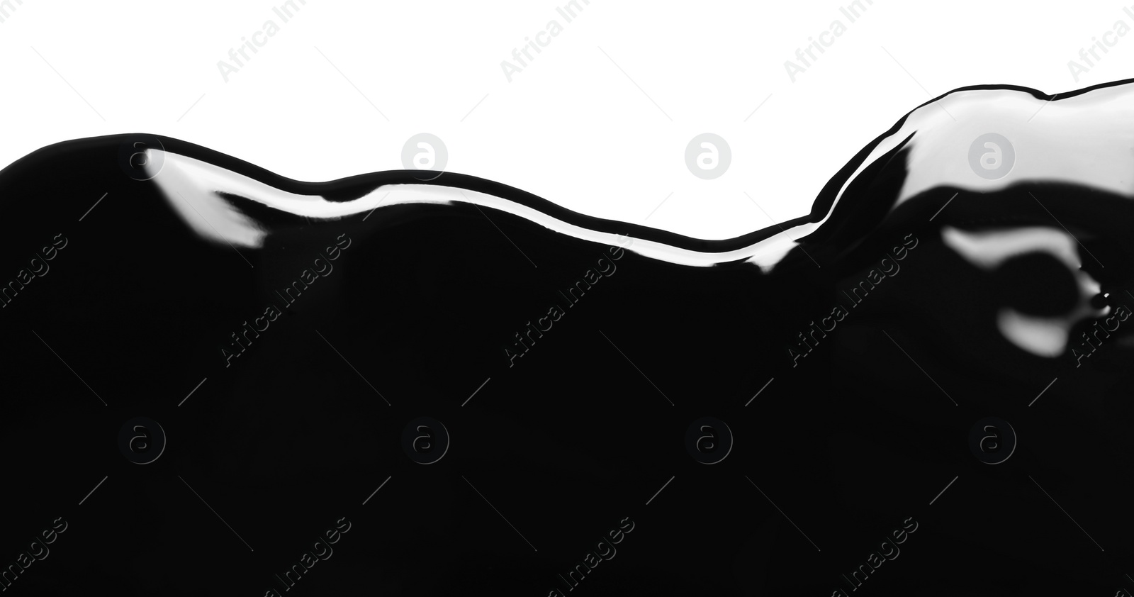 Photo of Black glossy paint spilled on white background, top view