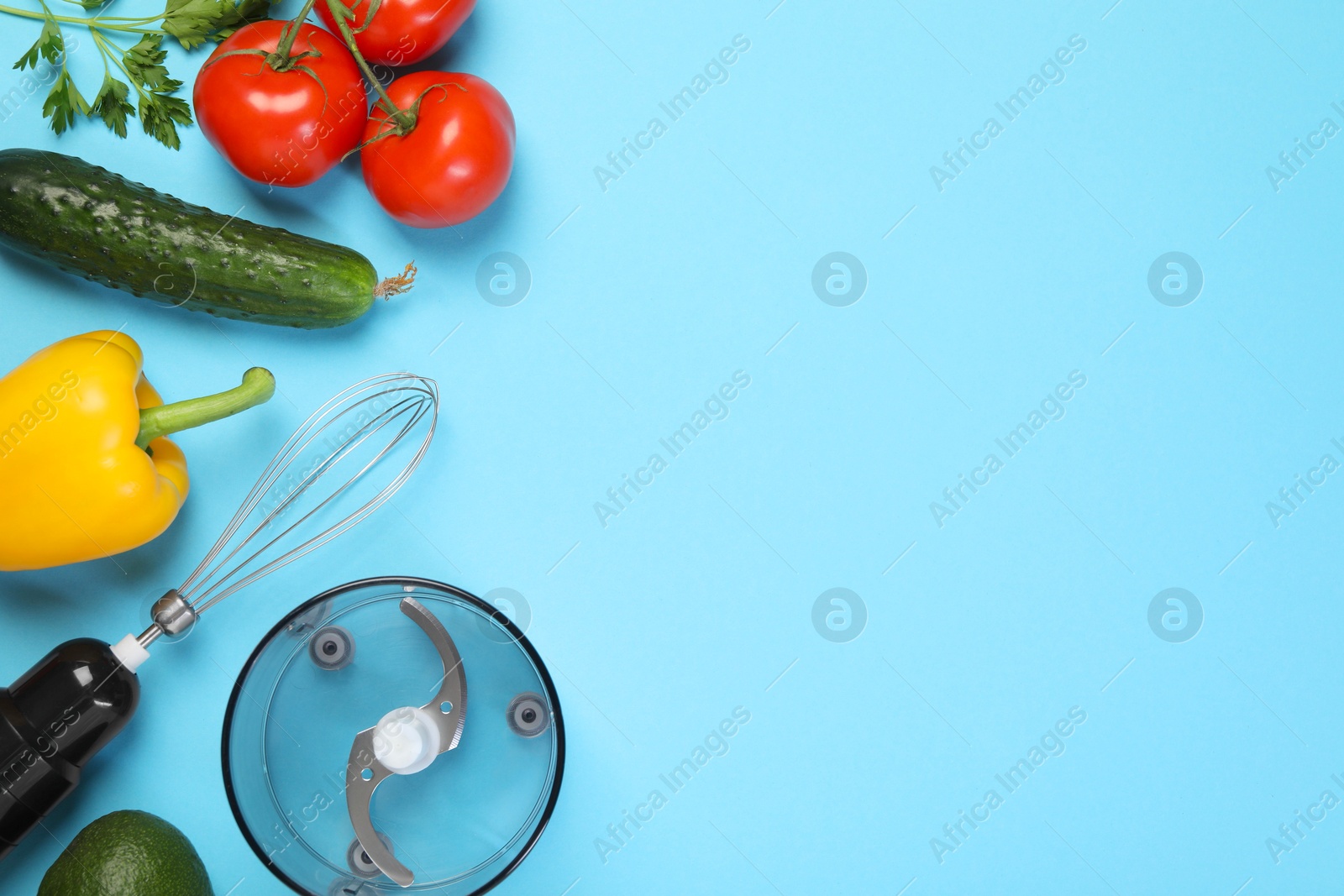 Photo of Hand blender kit and fresh products on light blue background, flat lay. Space for text