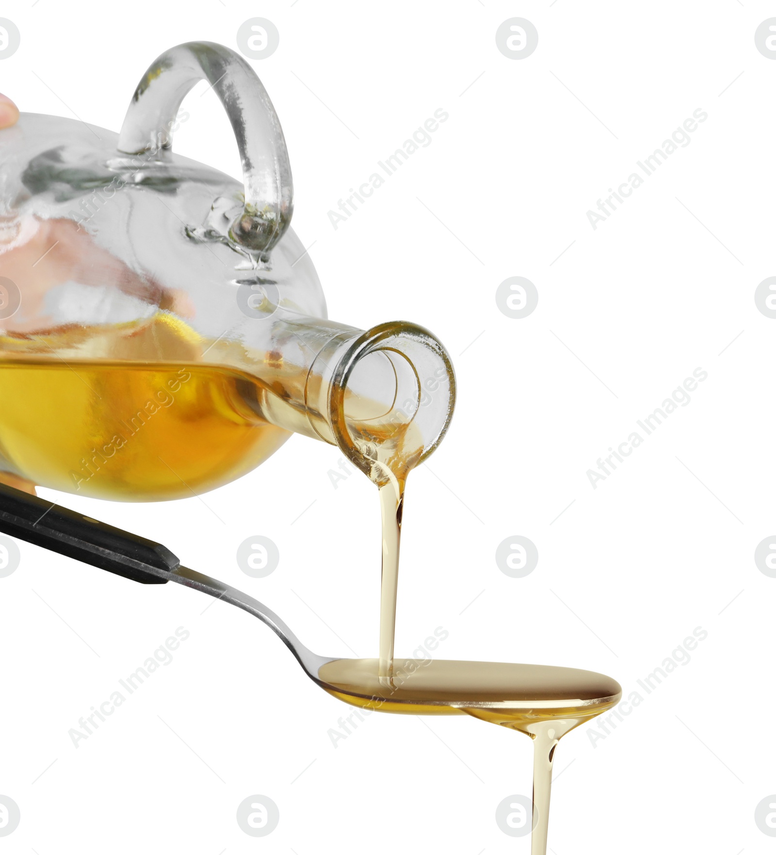 Photo of Pouring cooking oil from jug into spoon on white background, closeup