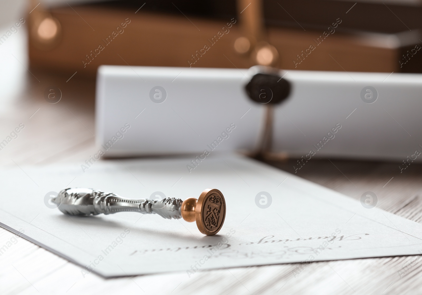 Photo of Vintage notary stamp and document on wooden table, closeup. Space for text