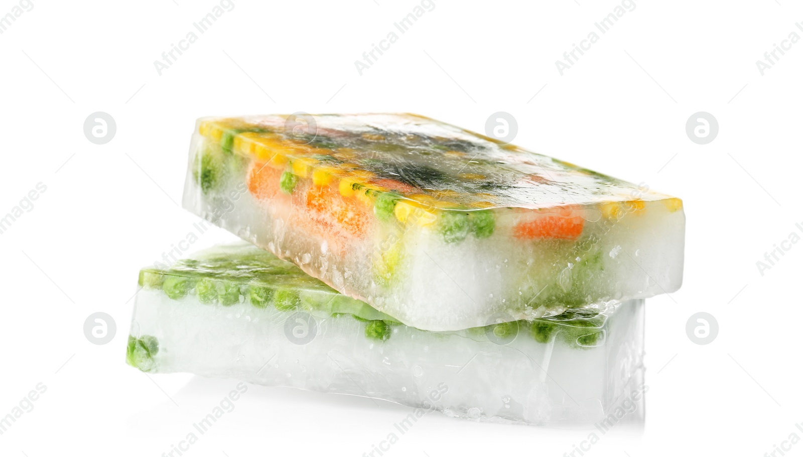 Photo of Fresh vegetables frozen in ice cubes on white background