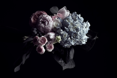 Photo of Beautiful bouquet of different flowers on black background. Floral card design with dark vintage effect