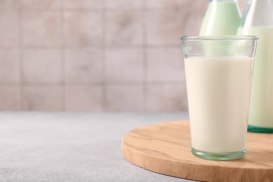 Glassware with tasty milk on table, closeup. Space for text