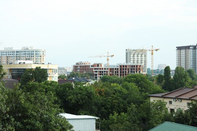 Multistoried residential buildings and construction cranes in city