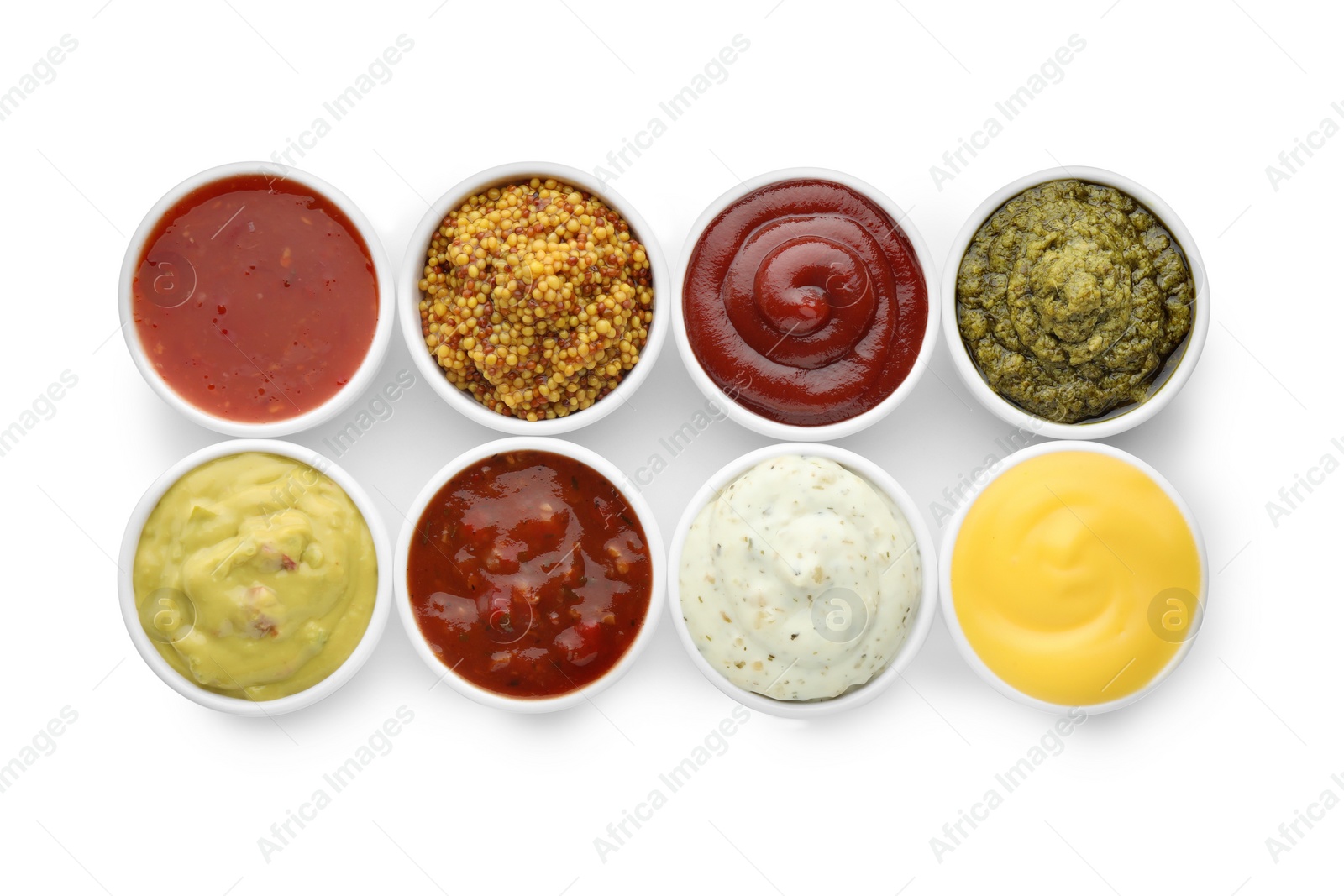 Photo of Many different sauces in bowls on white background, top view