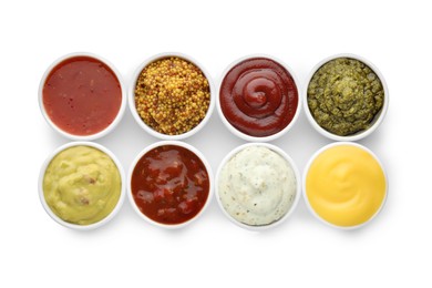 Photo of Many different sauces in bowls on white background, top view