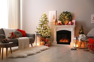 Stylish living room interior with beautiful fireplace, Christmas tree