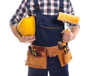 Photo of Construction worker with hard hat, paint roller and tool belt on white background, closeup