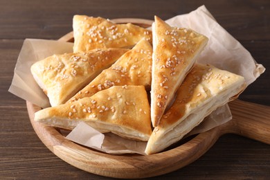 Delicious puff pastry on wooden table, closeup