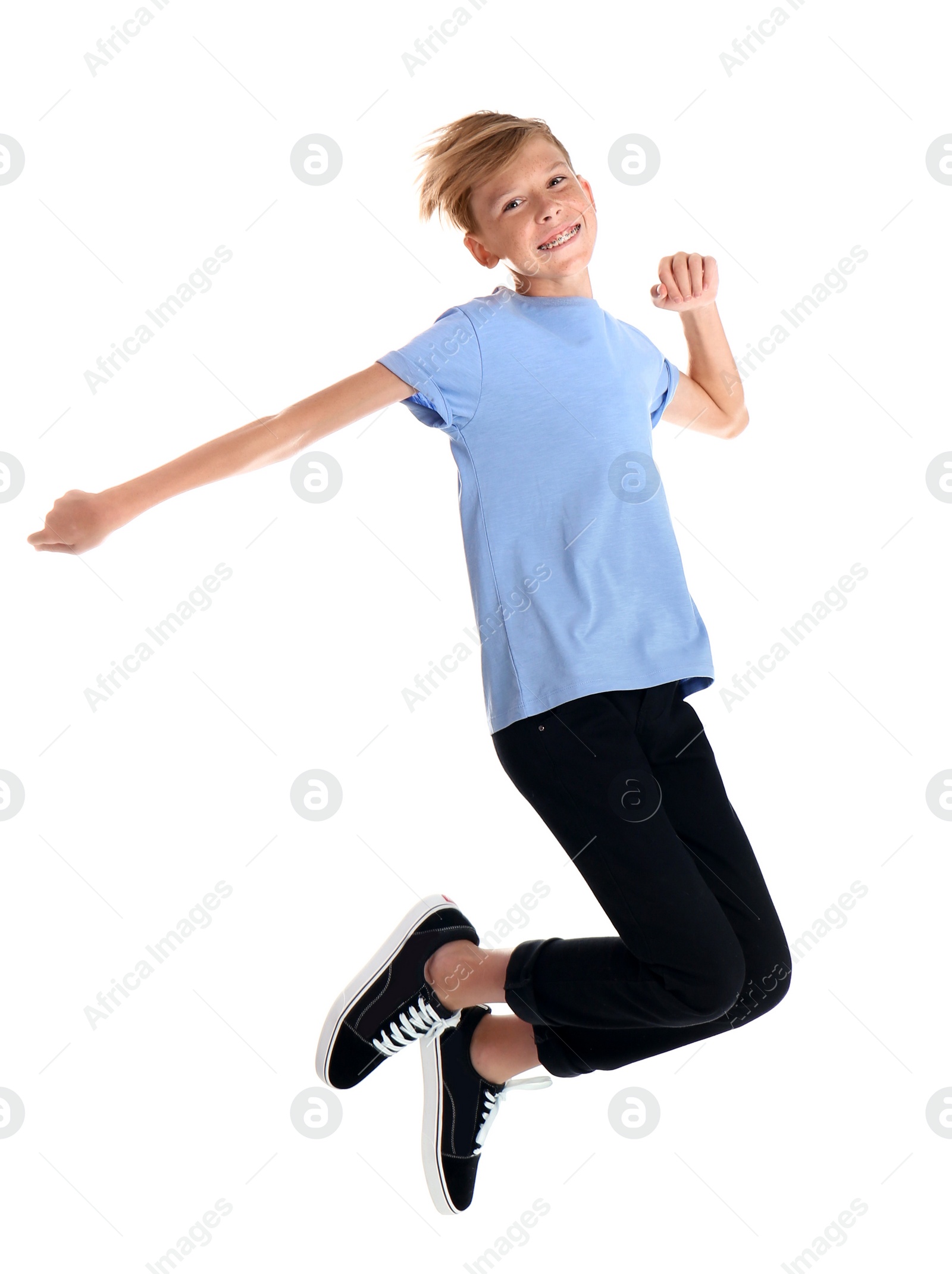 Photo of Portrait of young boy jumping on white background