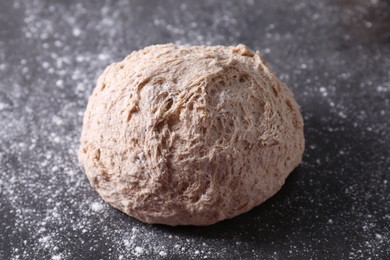 Fresh sourdough and flour on grey table