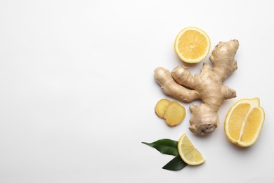 Photo of Fresh lemons and ginger on white background, flat lay. Space for text