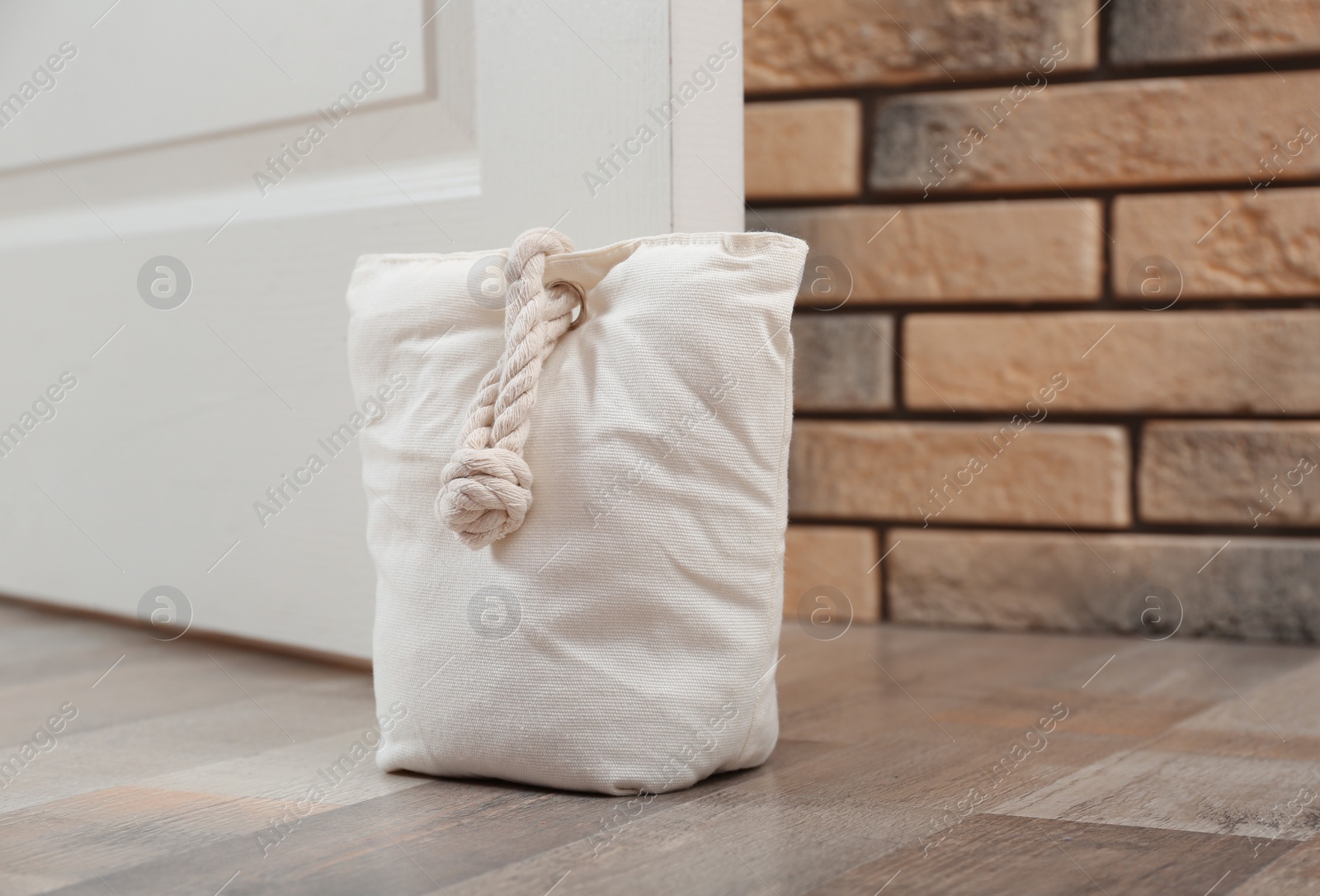 Stuffed bag holding wooden door at home Photo of Stuffed bag holding wooden door at home
