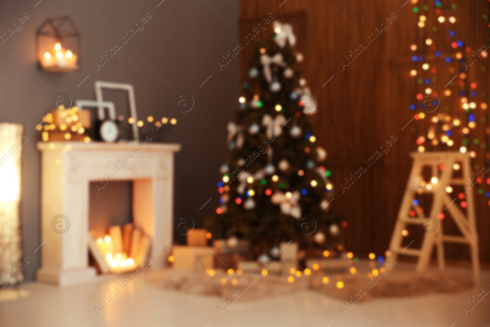 Photo of Blurred stylish room interior with Christmas tree and decorative fireplace