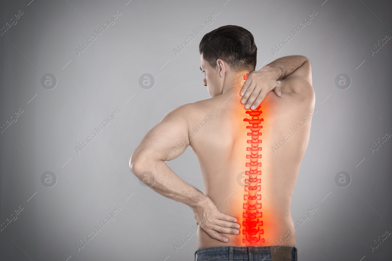 Image of Man suffering from pain in spine on grey background