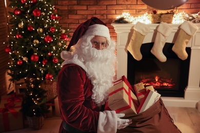 Santa Claus with sack of gifts in festively decorated room