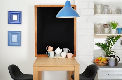 Photo of Cozy cafe interior with chalkboard and wooden table