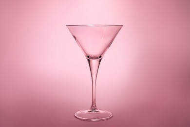 Photo of Elegant empty martini glass on pink background