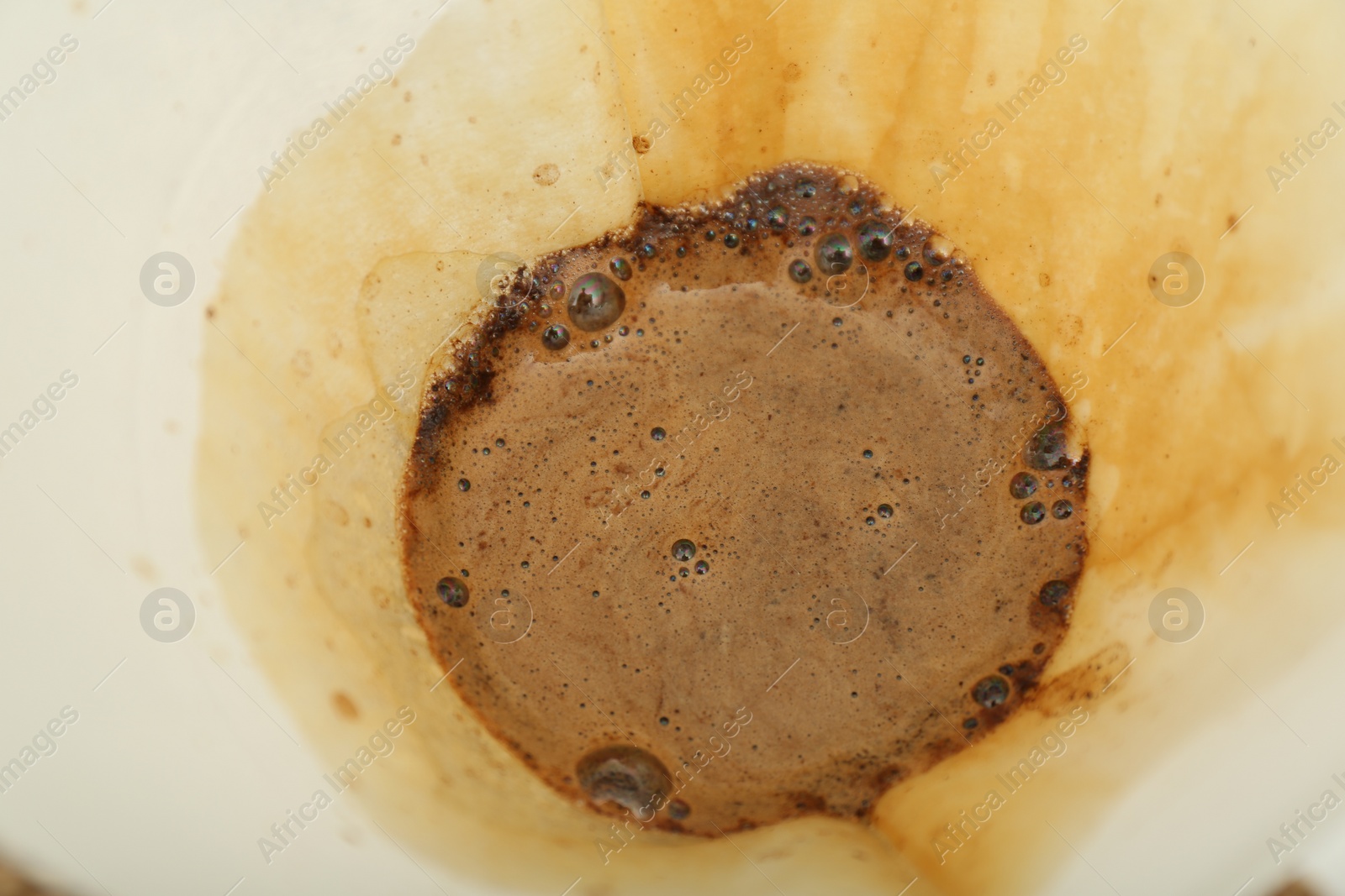 Photo of Paper filter with aromatic drip coffee, closeup