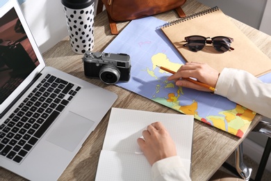 Photo of Woman with laptop planning trip at home, closeup. Summer vacation