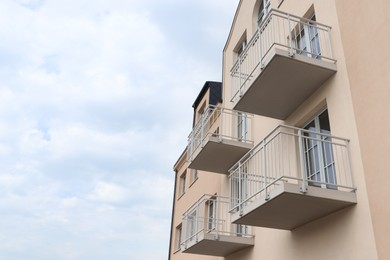 Photo of Exterior of beautiful building with empty balconies. Space for text