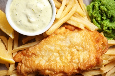 Photo of British traditional fish and potato chips, closeup