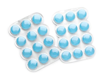 Blisters with blue cough drops on white background, top view