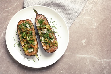 Photo of Flat lay composition with plate of stuffed eggplants and space for text on gray table