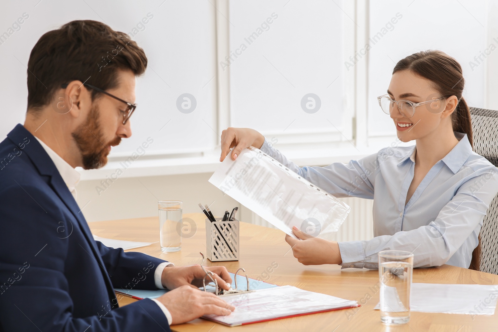 Photo of Businesspeople working together with documents in office