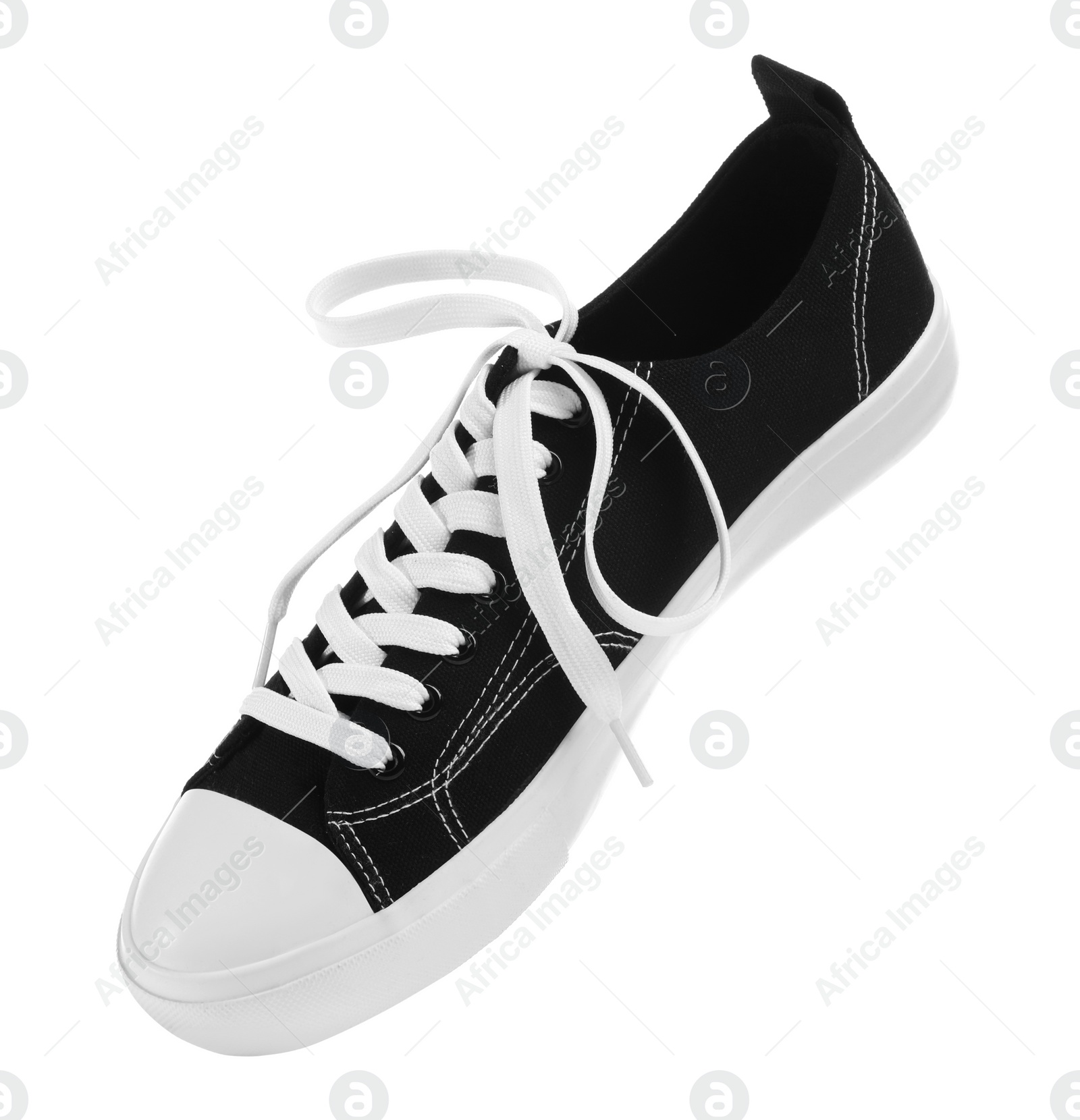 Photo of One black classic old school sneaker isolated on white