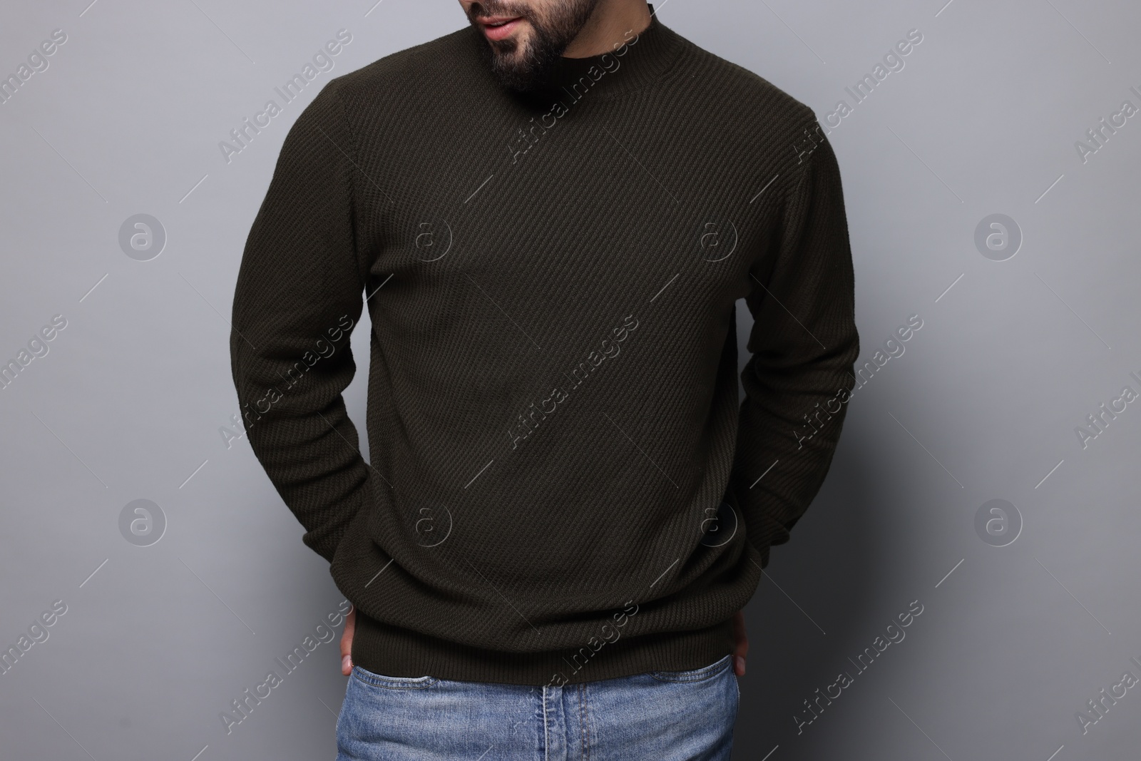 Photo of Man in stylish sweater on grey background, closeup