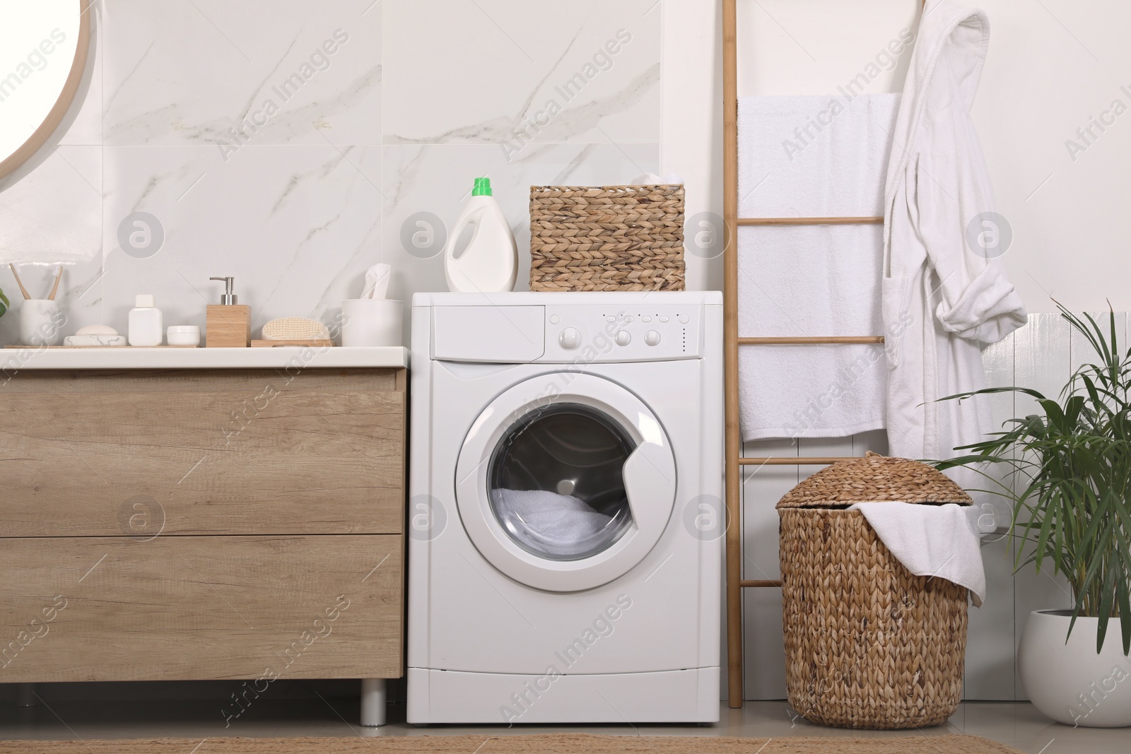 Photo of Stylish bathroom interior with modern washing machine