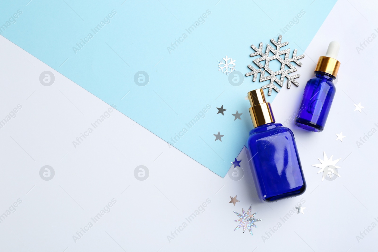 Photo of Flat lay composition with different cosmetic products on color background, space for text. Winter care