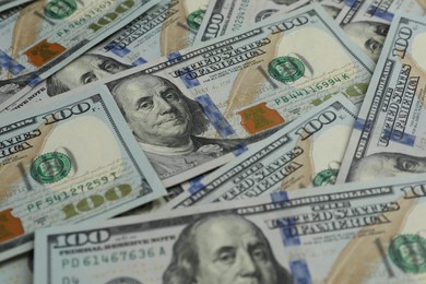 Photo of Money exchange. Dollar banknotes as background, closeup
