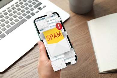 Spam warning message, envelope illustrations popping out of device display. Woman using email software on smartphone at table, closeup